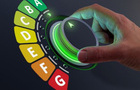 A hand turns an energy efficiency meter. 