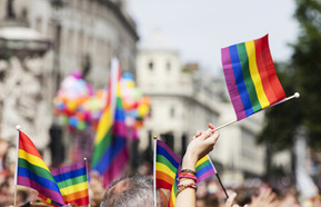  Waving rainbow flag at an LGBT pride march 