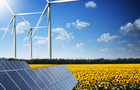 Green energy concept with solar panels and wind turbines on a sunflower field