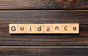 Guidance word written on wood block. Guidance text on table, concept