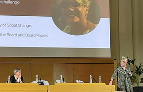 Debra Allcock Tyler in front of a podium