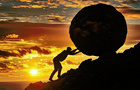 A person pushes a stone uphill