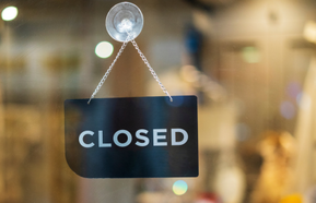 closed sign hanging on door