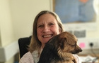 Photo of Henrietta Ireland cuddling her dog
