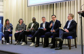 A panel of six engaging in a discussion