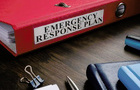 Red folder with Emergency response plan on the desk