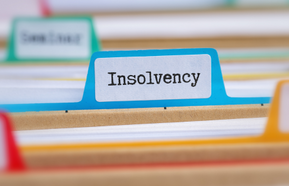 File folders with a tab labeled Insolvency