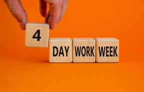 Person holds the cube with words '4 day work week'. 