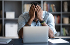 man with head in hands stress.jpg