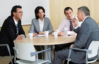 People sat around meeting table