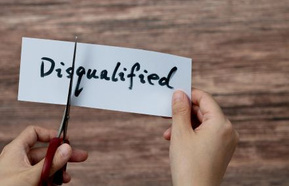 Scissors cutting word disqualified on paper
