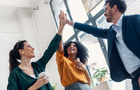 Three people celebrating good job while holding up their right hands up for a high five