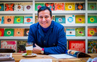 Martin Allen Morales sat at desk with a drink